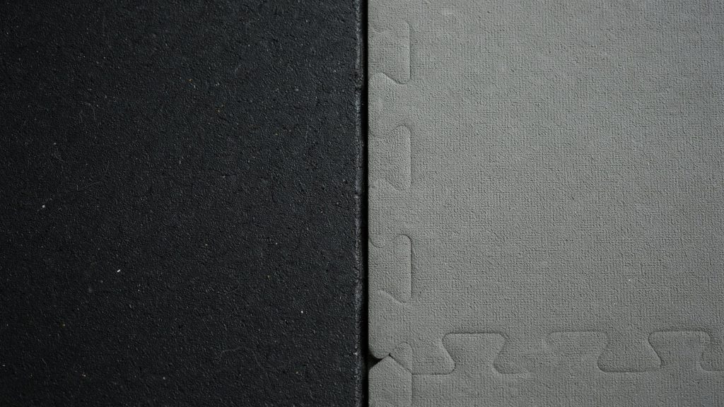 Comparison of heavy duty rubber gym mats vs foam tiles in a clean home workout space