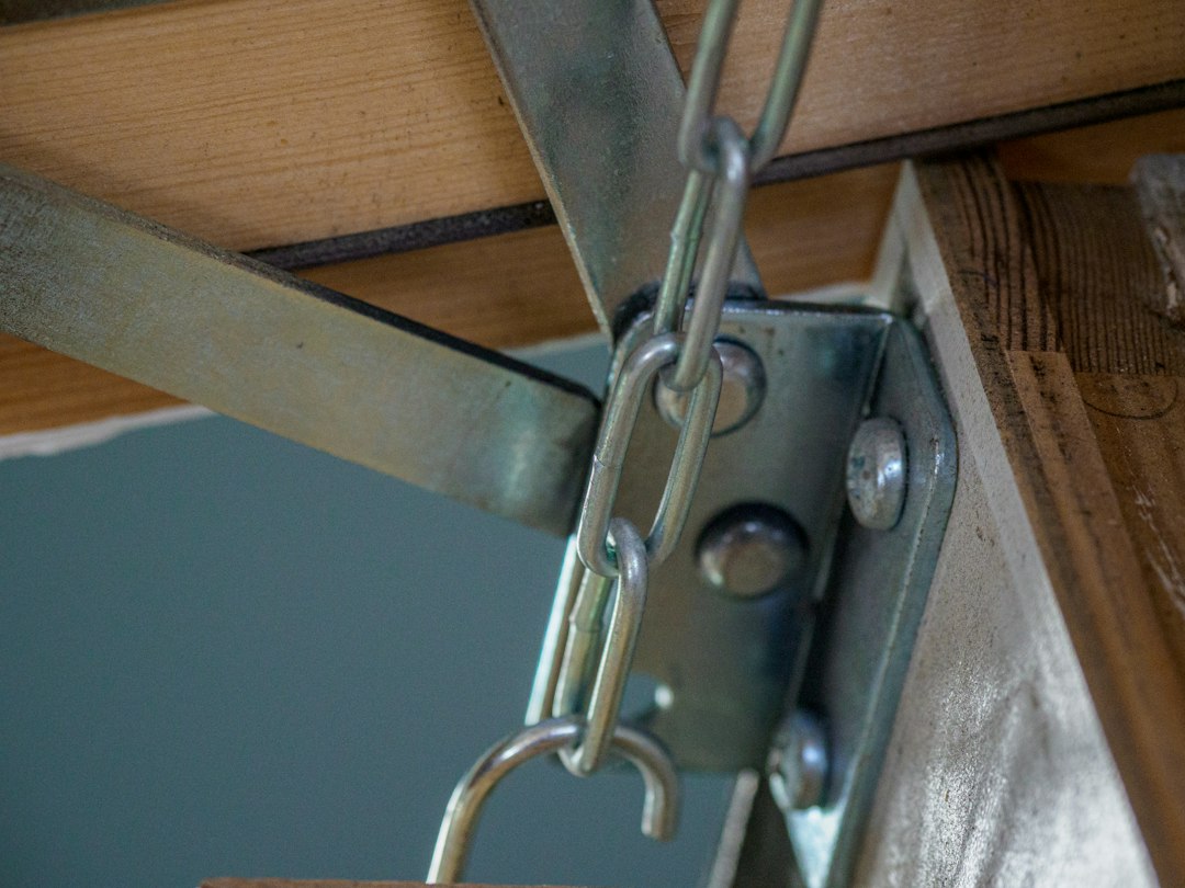 Foldable Squat Rack Apartment Guide: Footprint, Installation, and Safety 3 Close-up detail of heavy-duty steel hinge and locking pin mechanism on a folding squat rack.